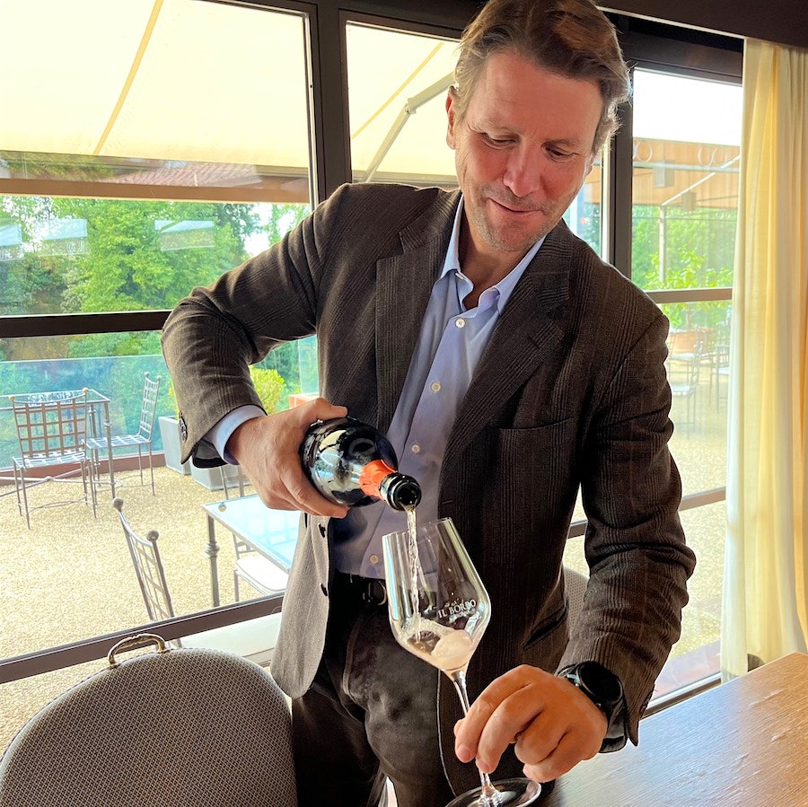Salvatore Ferragamo pouring a glass of wine inside the Il Borro Tuscan Bistro